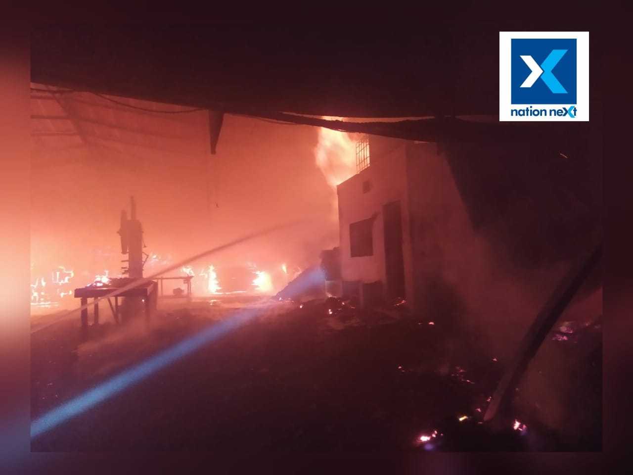 Firemen try to douse the fire at the saw mill in Nagpur 
